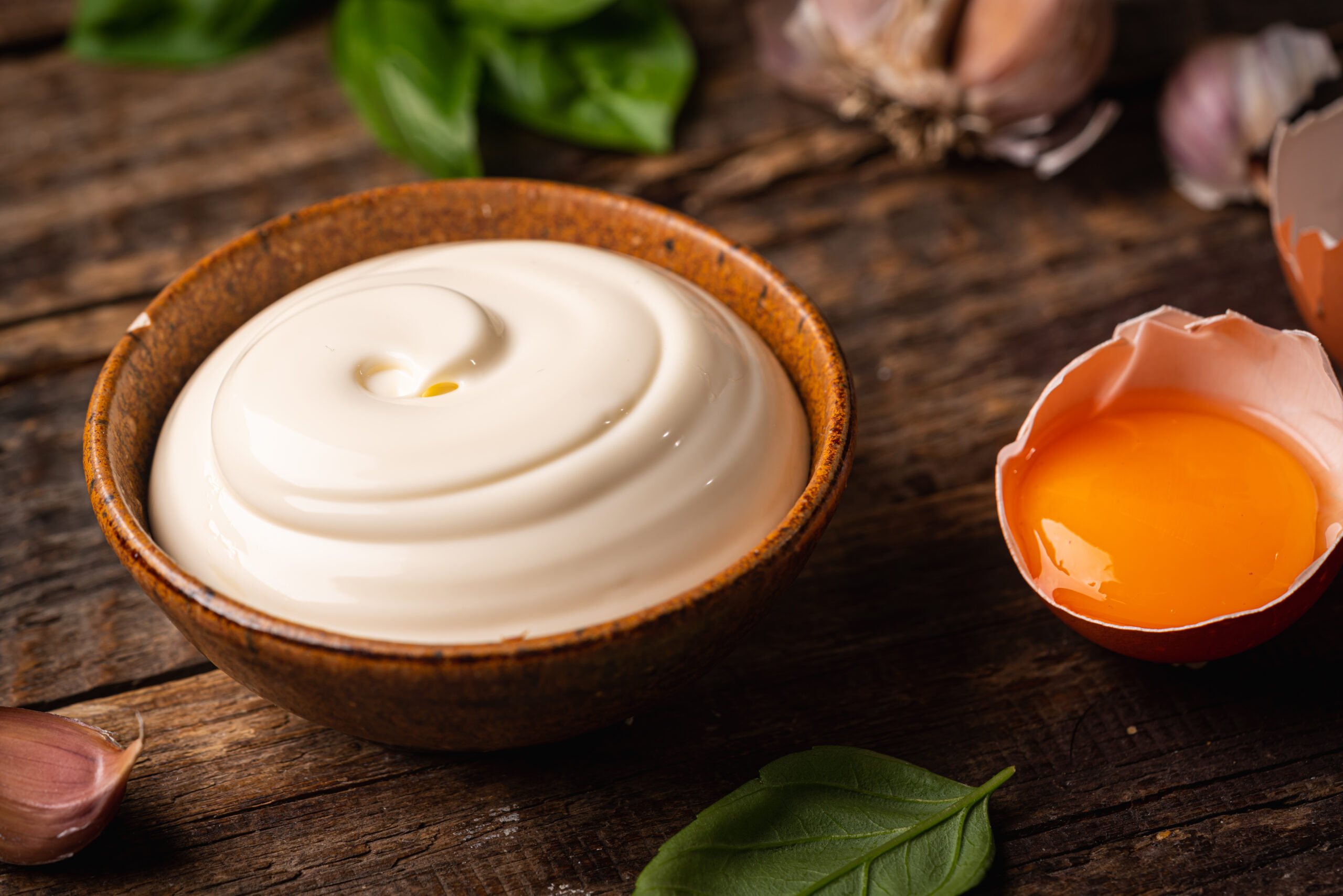 Bowl of Homemade mayonnaise sauce with ingredients and herbs for cooking