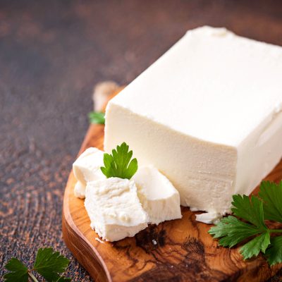 Feta cheese on rusty background. Selective focus