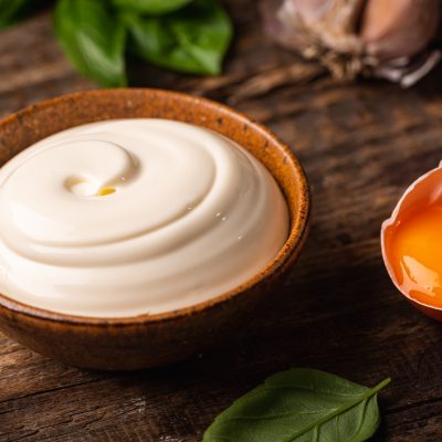 Bowl of Homemade mayonnaise sauce with ingredients and herbs for cooking